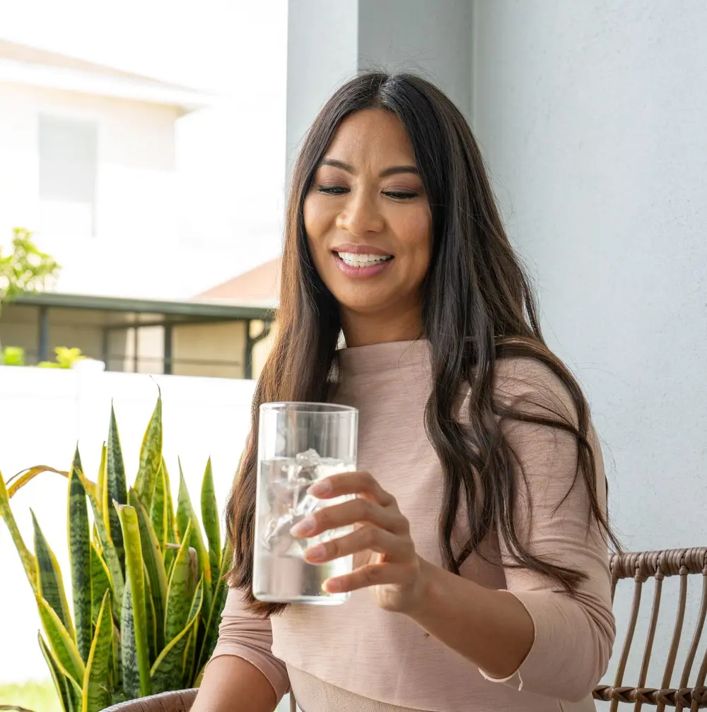 A woman enjoying a glass of water