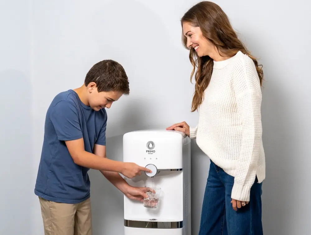 A Mother and son use a Primo Water bottom load dispenser