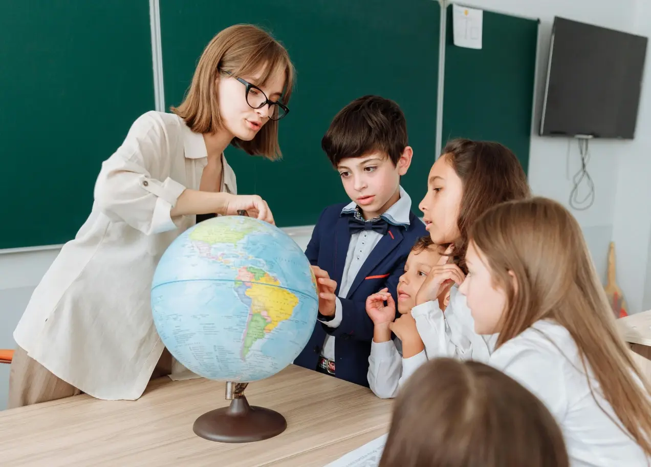A teacher teaching students using the world globe