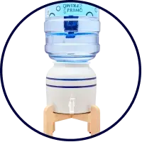 A countertop bottled water dispenser with a large blue water jug on top, resting on a wooden stand, featuring a spout for dispensing water.